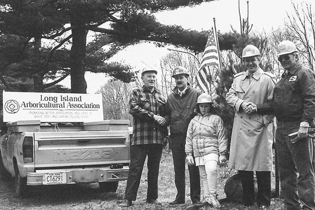 Black and white photo with Long Island Arborcultural Association truck and people.
