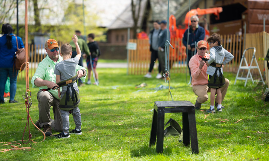 Wonderland Tree Care staff teaching children at a tree care event.